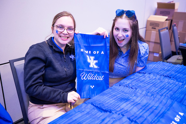 Students holding Home of a Wildcat yard flag