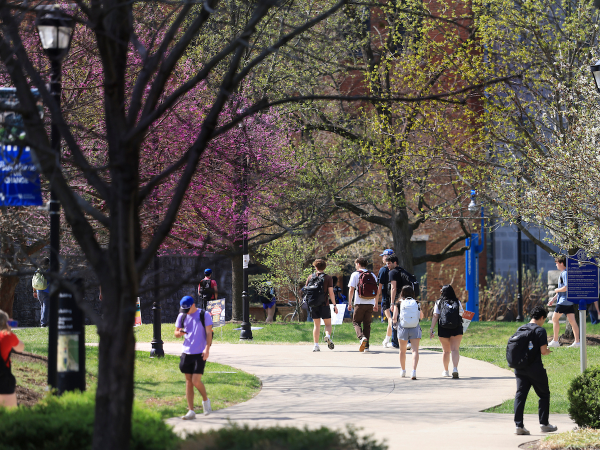 Students walking on campus at springtime