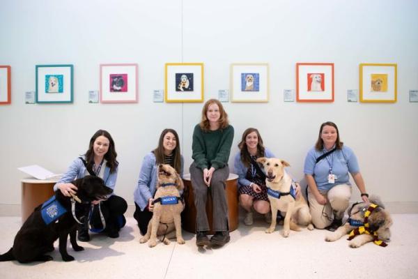The canine counselors inspired the colorful creation of Katie Belle’s exhibit that brightens the hall of Kentucky Children’s Hospital. 