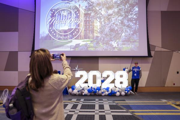 Student having their photo made with UK 2028 sign at orientation