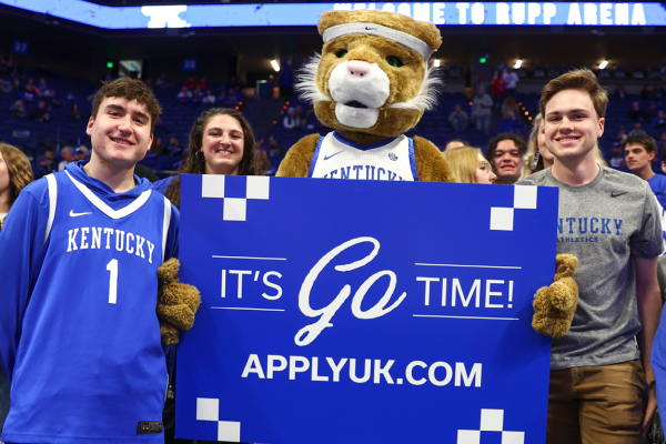 Wildcat and students with sign that says it's go time applyuk.com