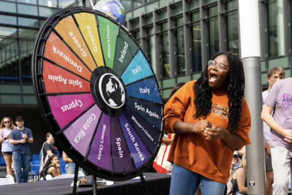 Student spinning wheel at education abroad fair