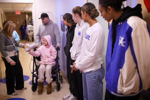 women's team and pediatric cancer patient with painted shoes