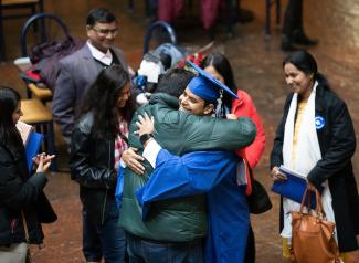 Student hugging parent at Commencement