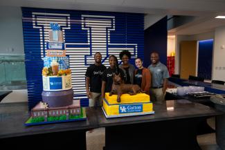 Photo of students with cake at grand opening of Gatton Student Center