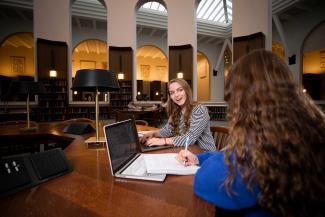 Two students studying in a library