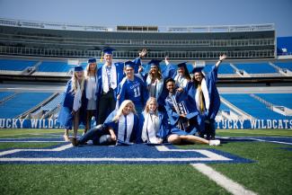 Photo of students in cap and gown at Kroger Field