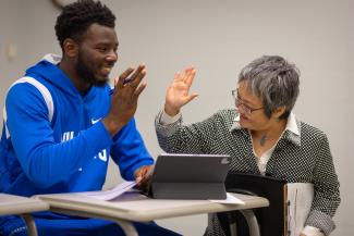 Dr. Tanaka and student high fiving