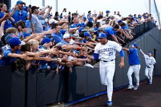 Baseball team shaking hands with crowd