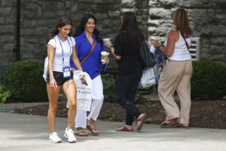 Mother and daughter walking on campus