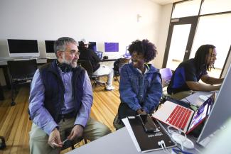 Student and professor chatting in CI classroom