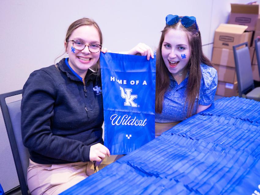 Students holding Home of a Wildcat yard flag