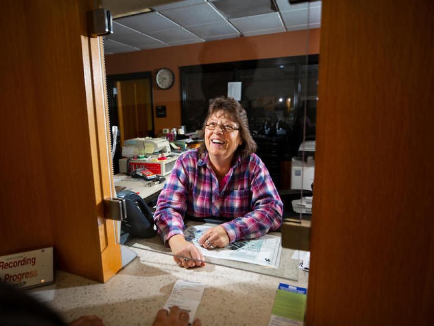 Transportation services employee behind desk.