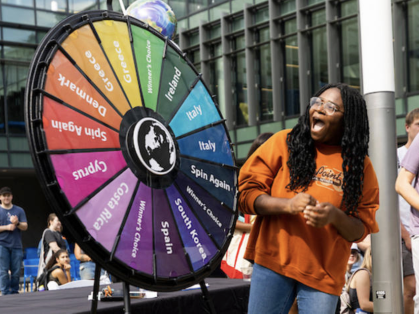 Student spinning wheel at education abroad fair