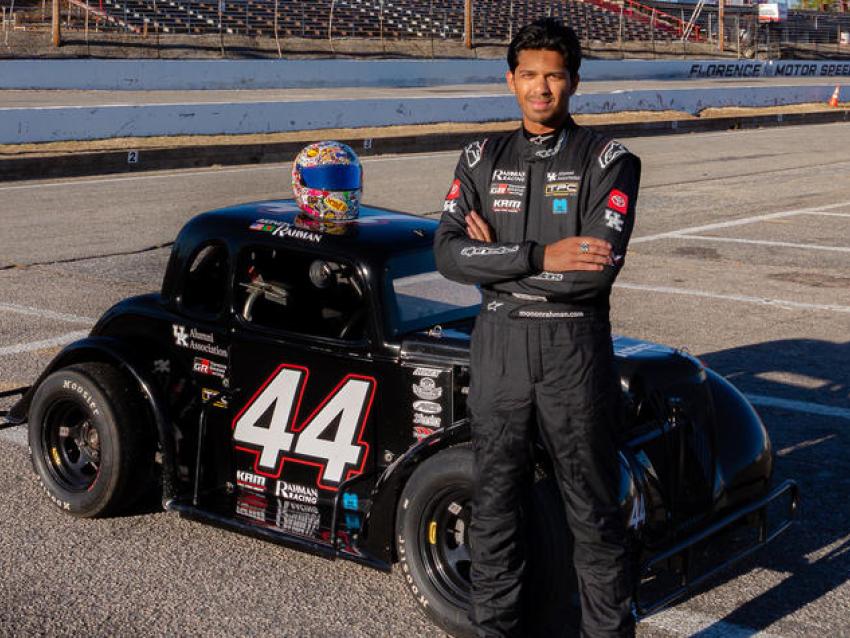 Rahman standing next to racecar