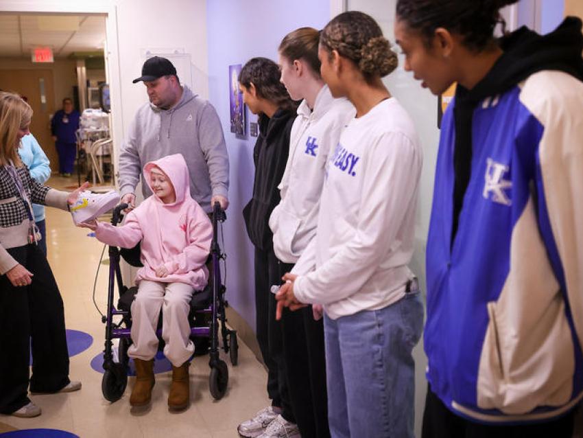women's team and pediatric cancer patient with painted shoes