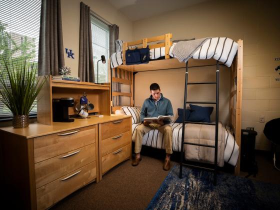 Male student sitting in residence hall room