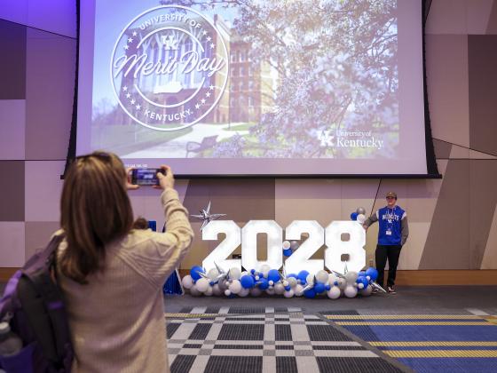 Student having their photo made with UK 2028 sign at orientation