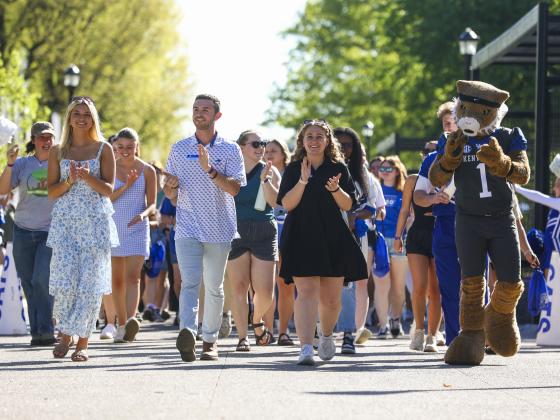 Students walking through Alumni Commons gate as they prepare for graduation